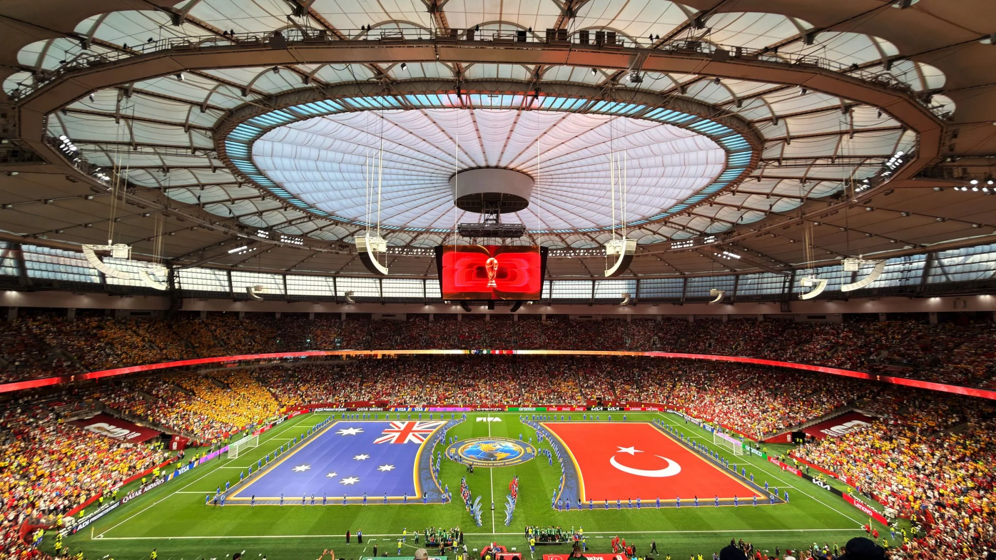 Vibrant soccer match at BC Place, Vancouver, showcasing international team flags.