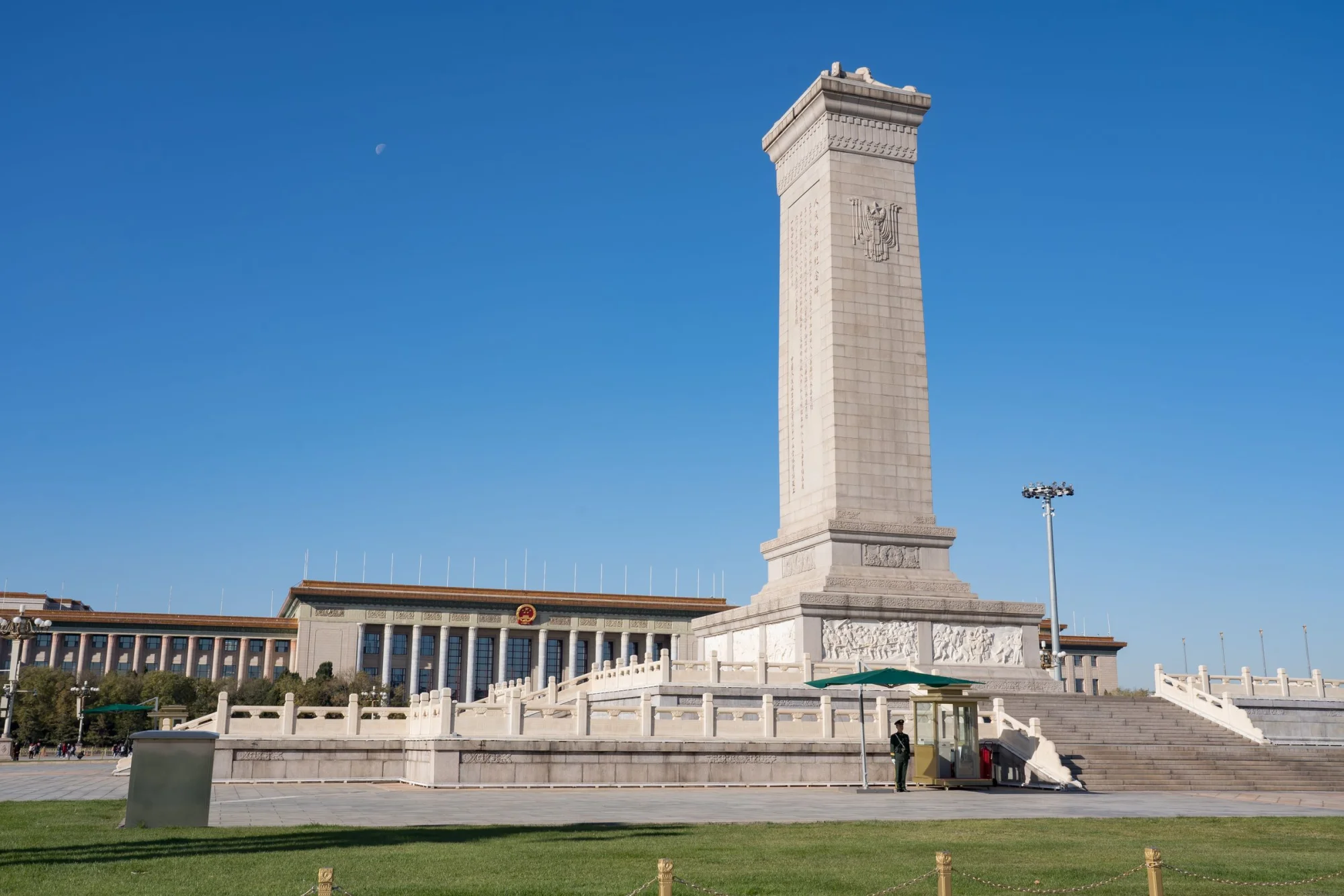 Monument to the People's Heroes in Tiananmen Square, Beijing, China, under a clear blue sky.