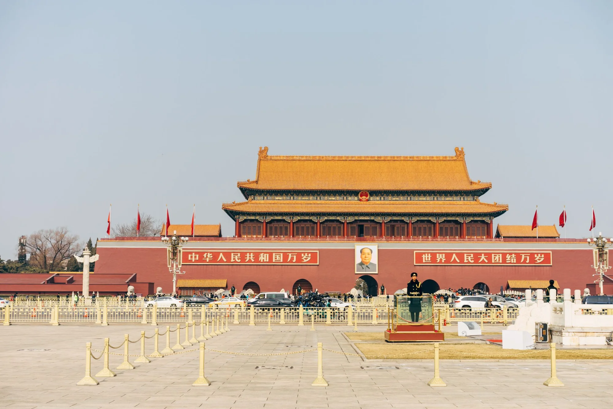 Explore the iconic Tiananmen Square with historic architecture under a clear blue sky.