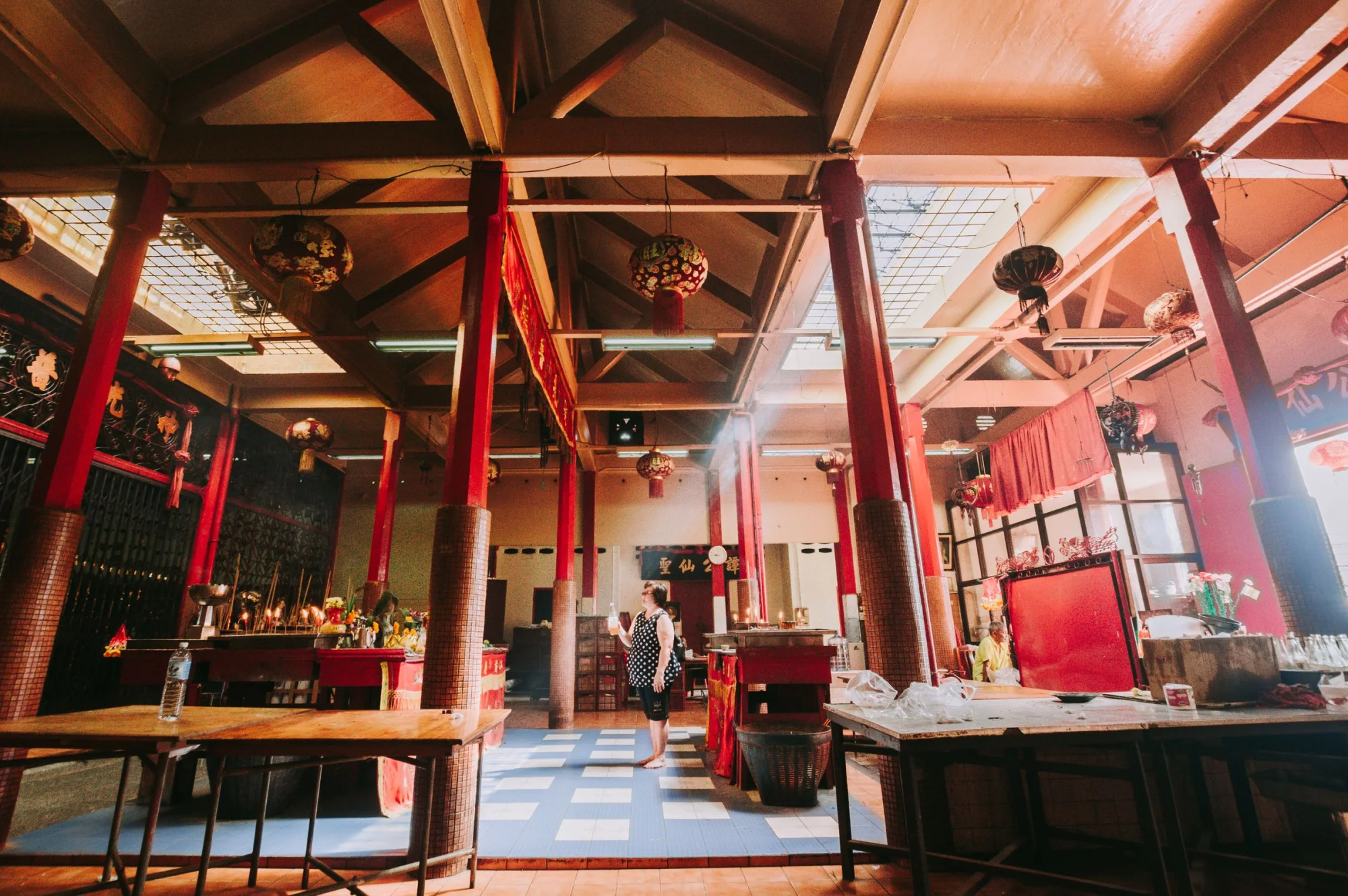 Explore a serene shrine interior with vibrant decor in Trang, Thailand, showcasing cultural heritage.