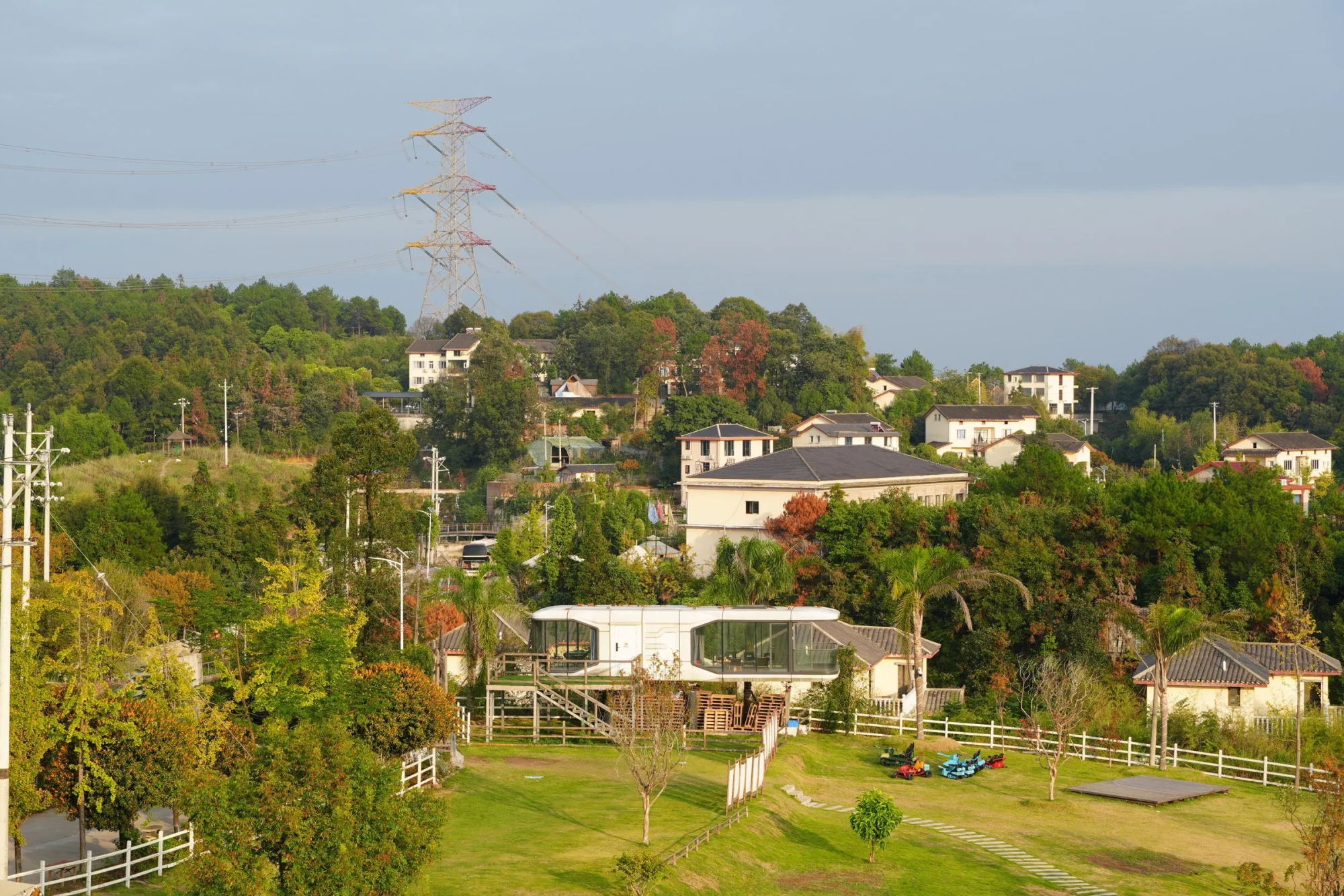Scenic aerial view of a suburban neighborhood surrounded by lush greenery and hills.