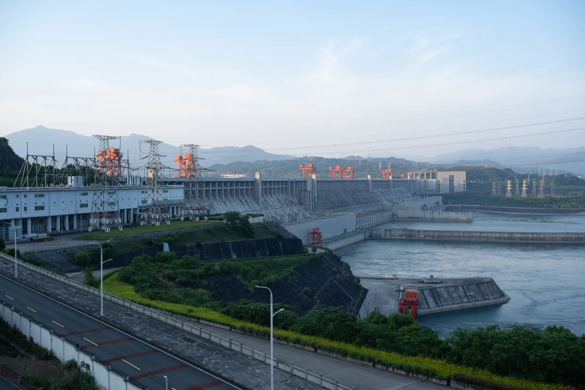 Wide shot of the Three Gorges Dam in China, showcasing its massive structure and surrounding landscape.