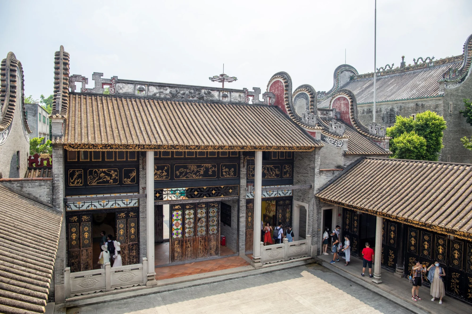 A view of the Foshan Ancestral Temple showcasing traditional architecture and tourists exploring.