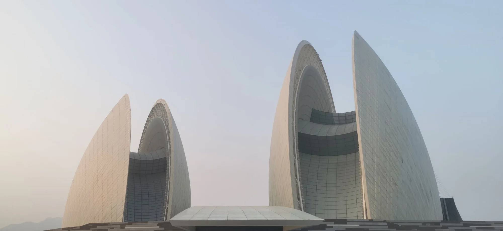 Stunning view of the futuristic Zhuhai Opera House in Guangdong, China with clear sky backdrop.
