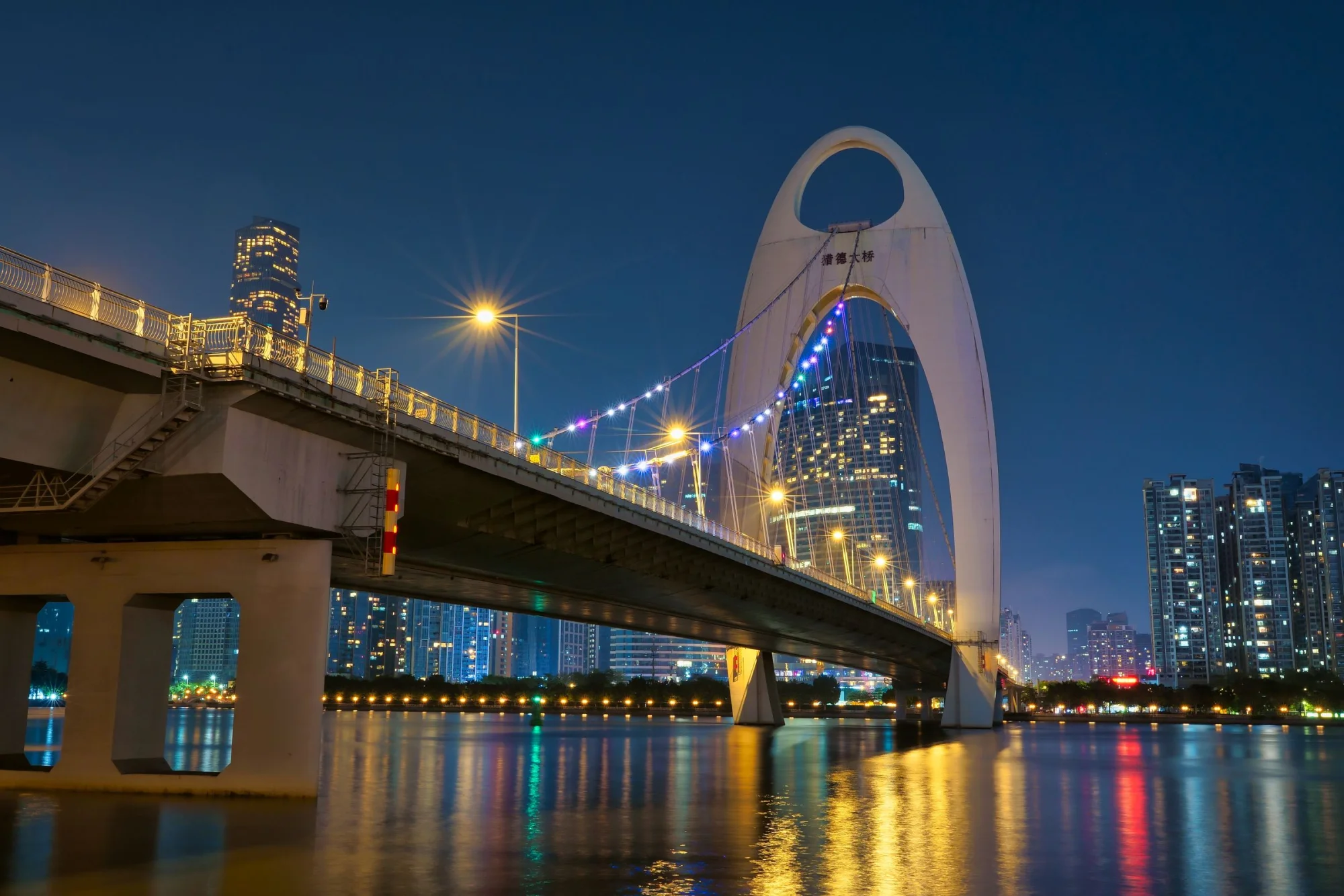 Stunning view of the illuminated Liede Bridge in Guangzhou, showcasing modern architecture against a night skyline.