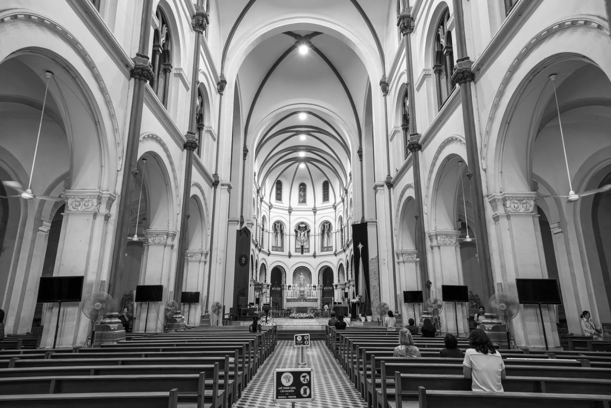 Explore the grand architectural beauty of Notre-Dame Cathedral Saigon's interior in stunning black and white.