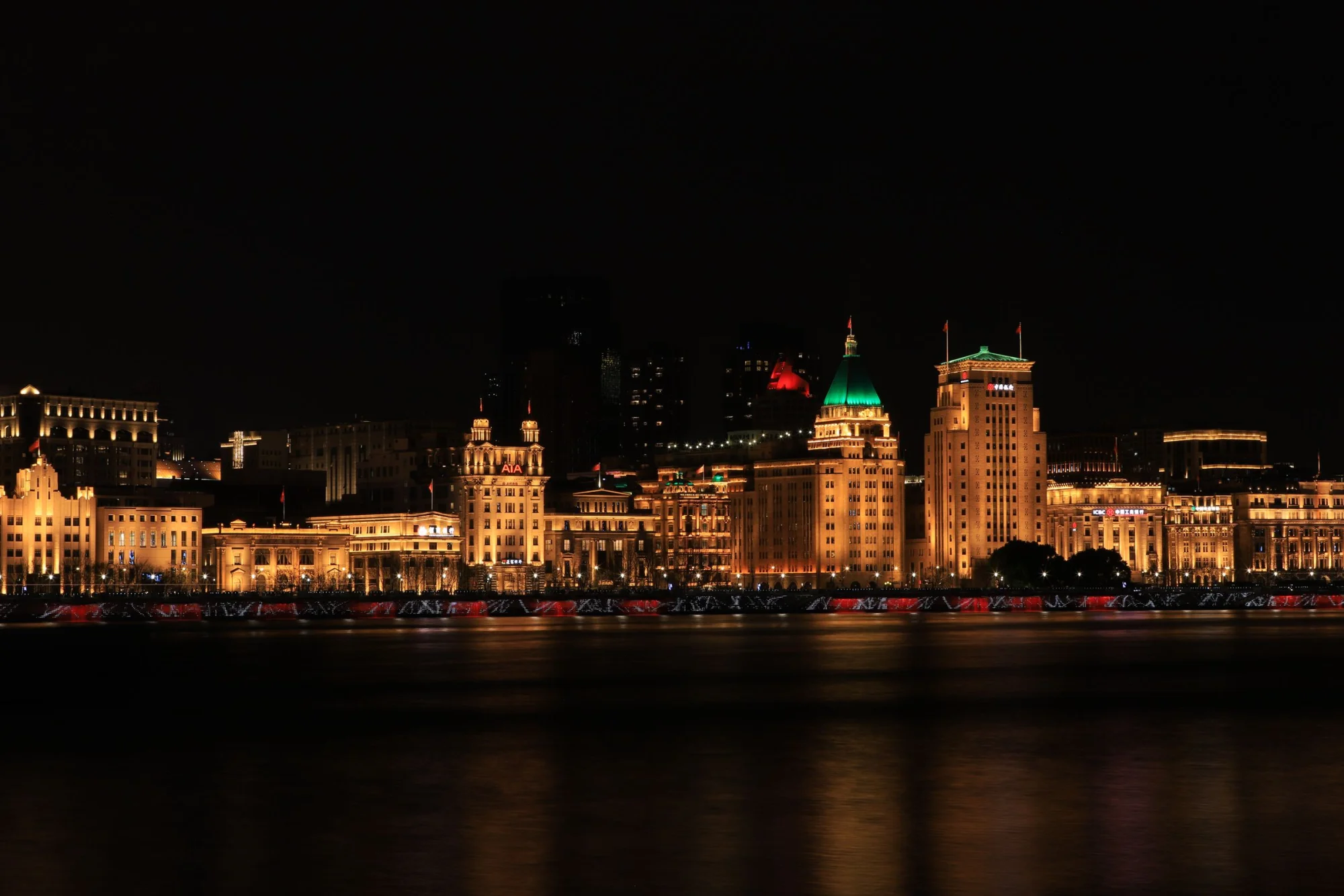 Stunning night view of Shanghai's Bund, showcasing illuminated historic buildings along the waterfront.