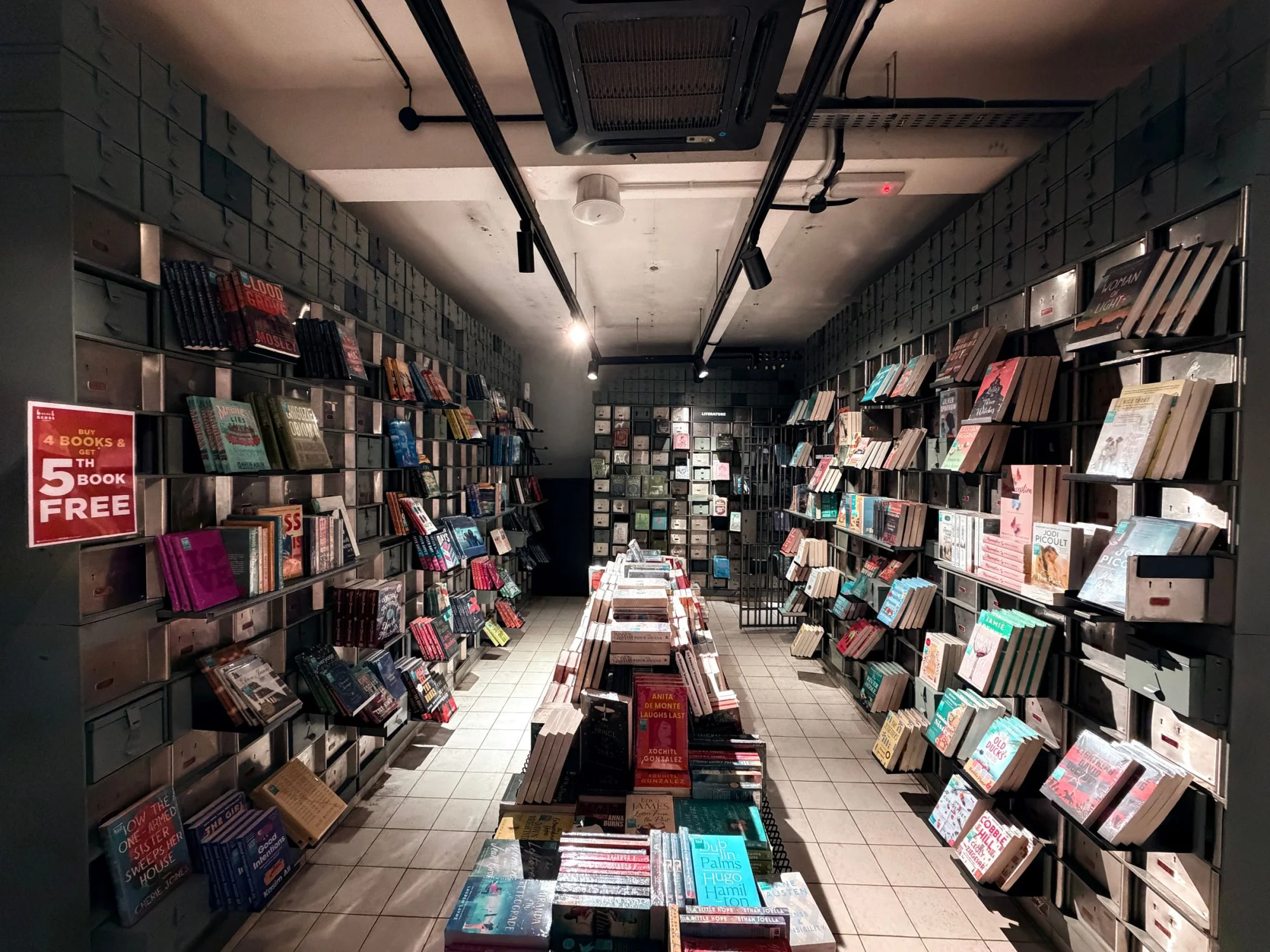 Explore a modern bookstore in Ipoh with neatly arranged shelves and warm lighting.
