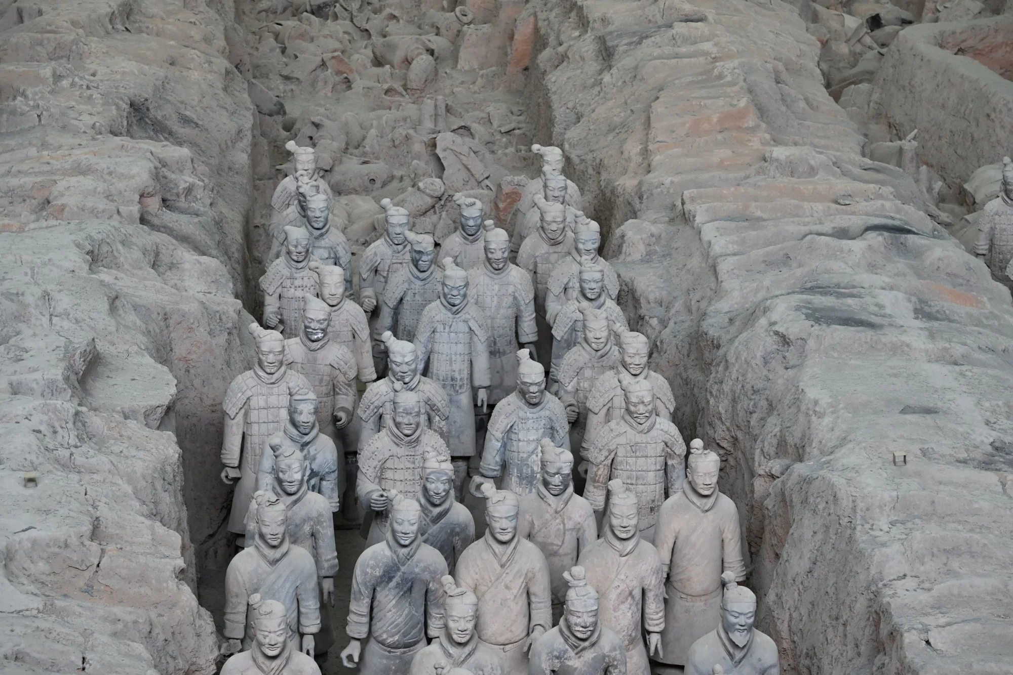 Ancient Terracotta Army site with rows of clay soldiers representing Qin Shi Huang's forces.