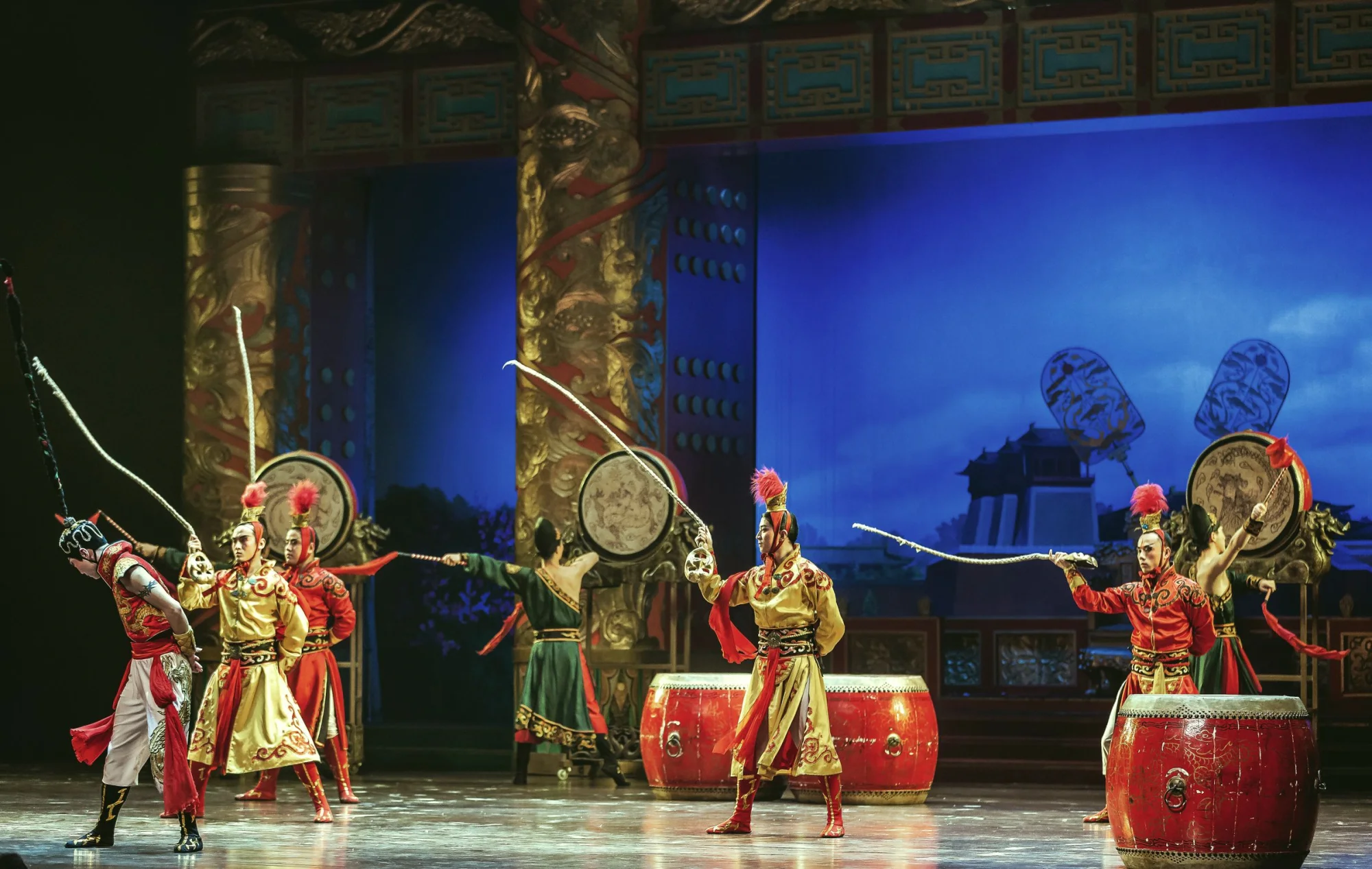 Vibrant traditional Chinese performance with dancers in colorful costumes on stage.