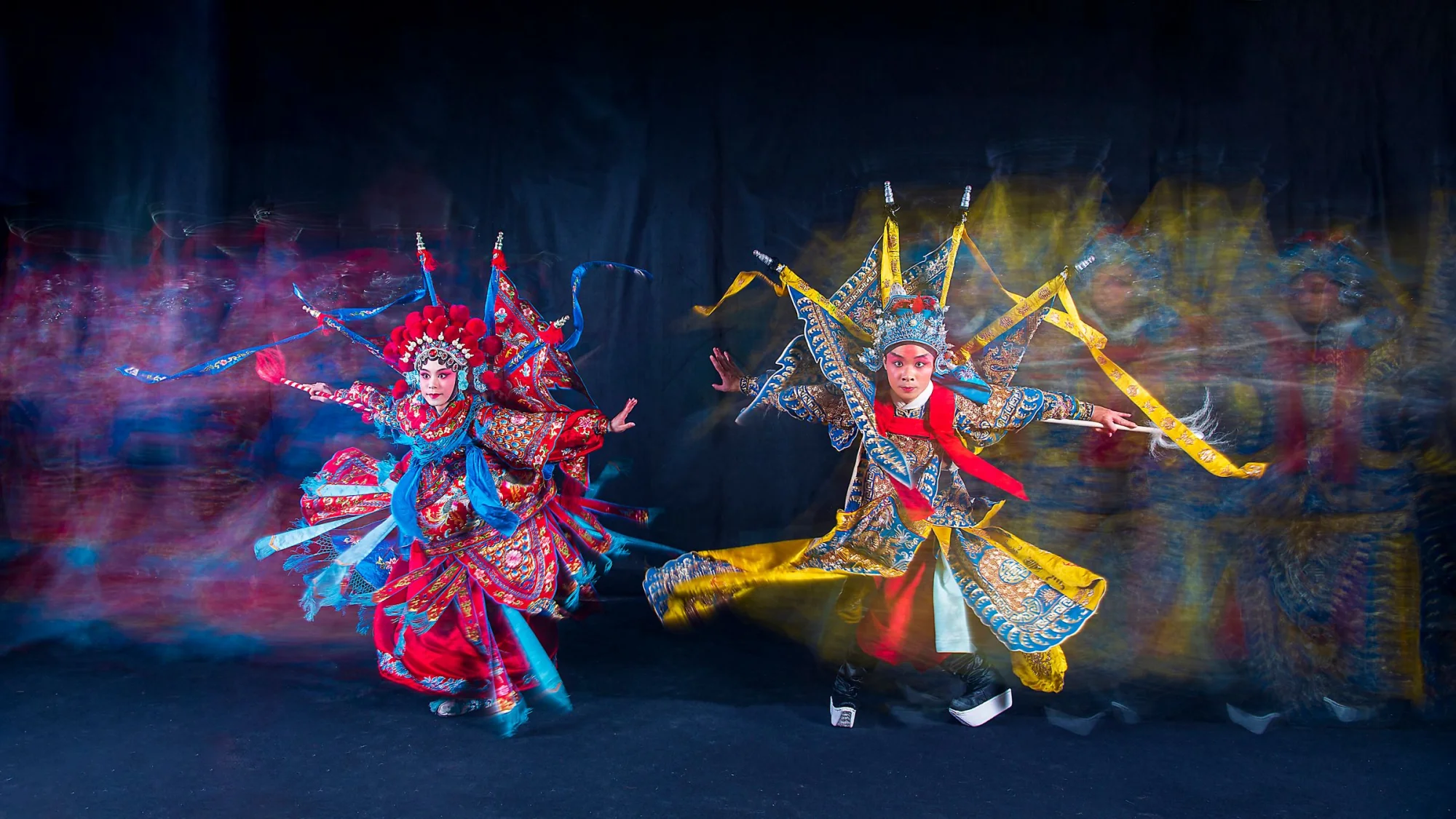 Dynamic capture of performers in traditional costumes during a Taiwanese opera performance.