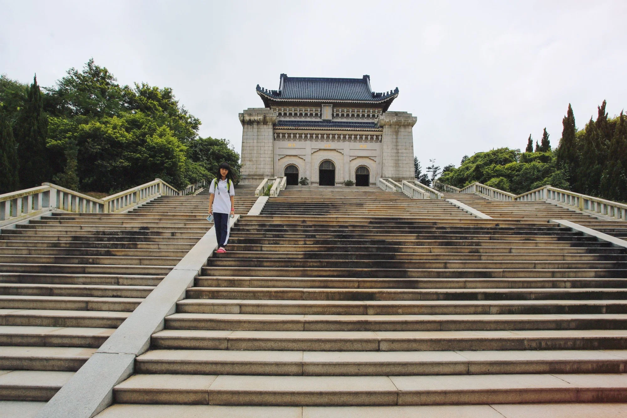 A woman descends the steps of the historic Sun Yat-sen Mausoleum in Nanjing, China.