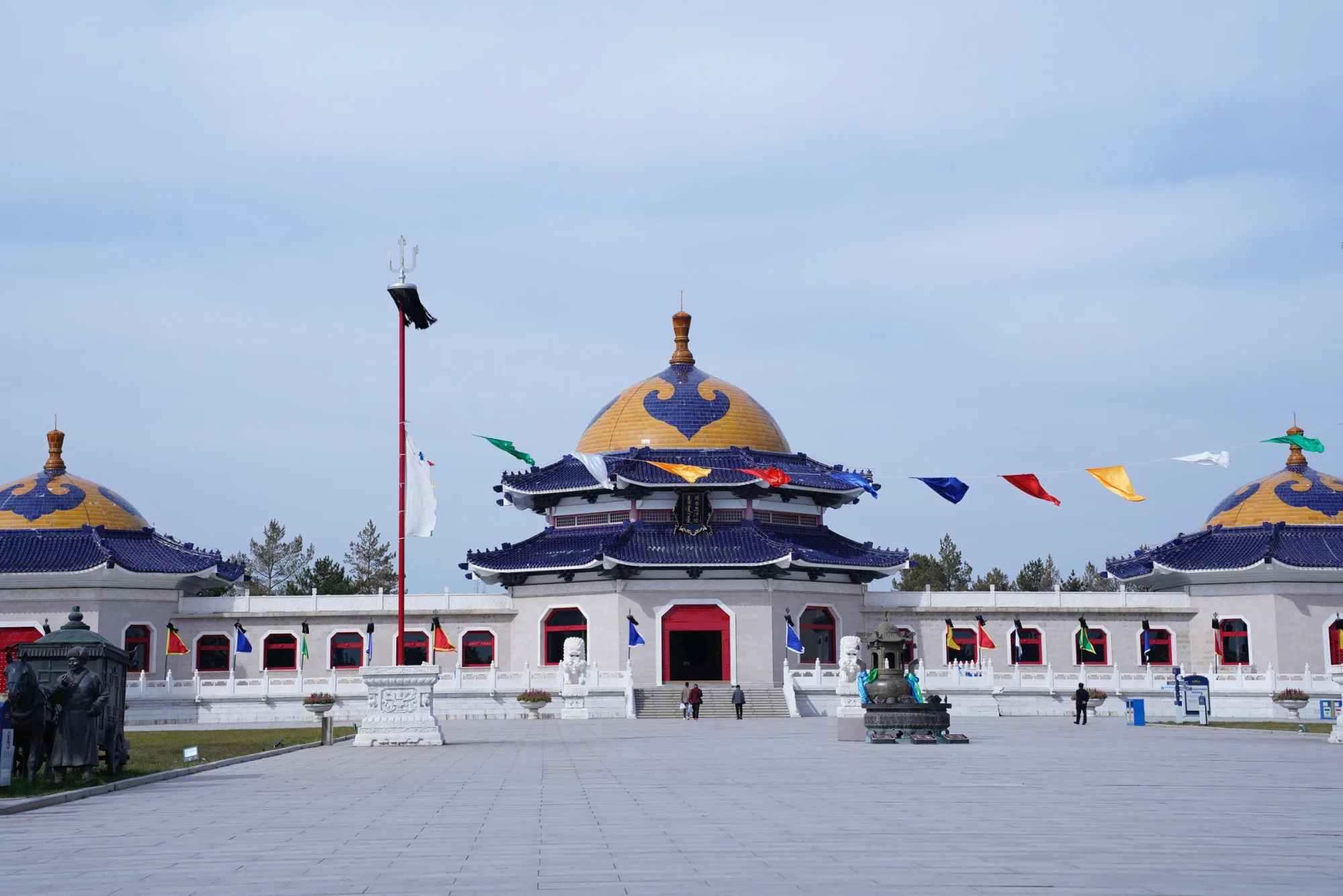 Beautiful view of a historic mausoleum with vibrant banners, showcasing traditional architecture.