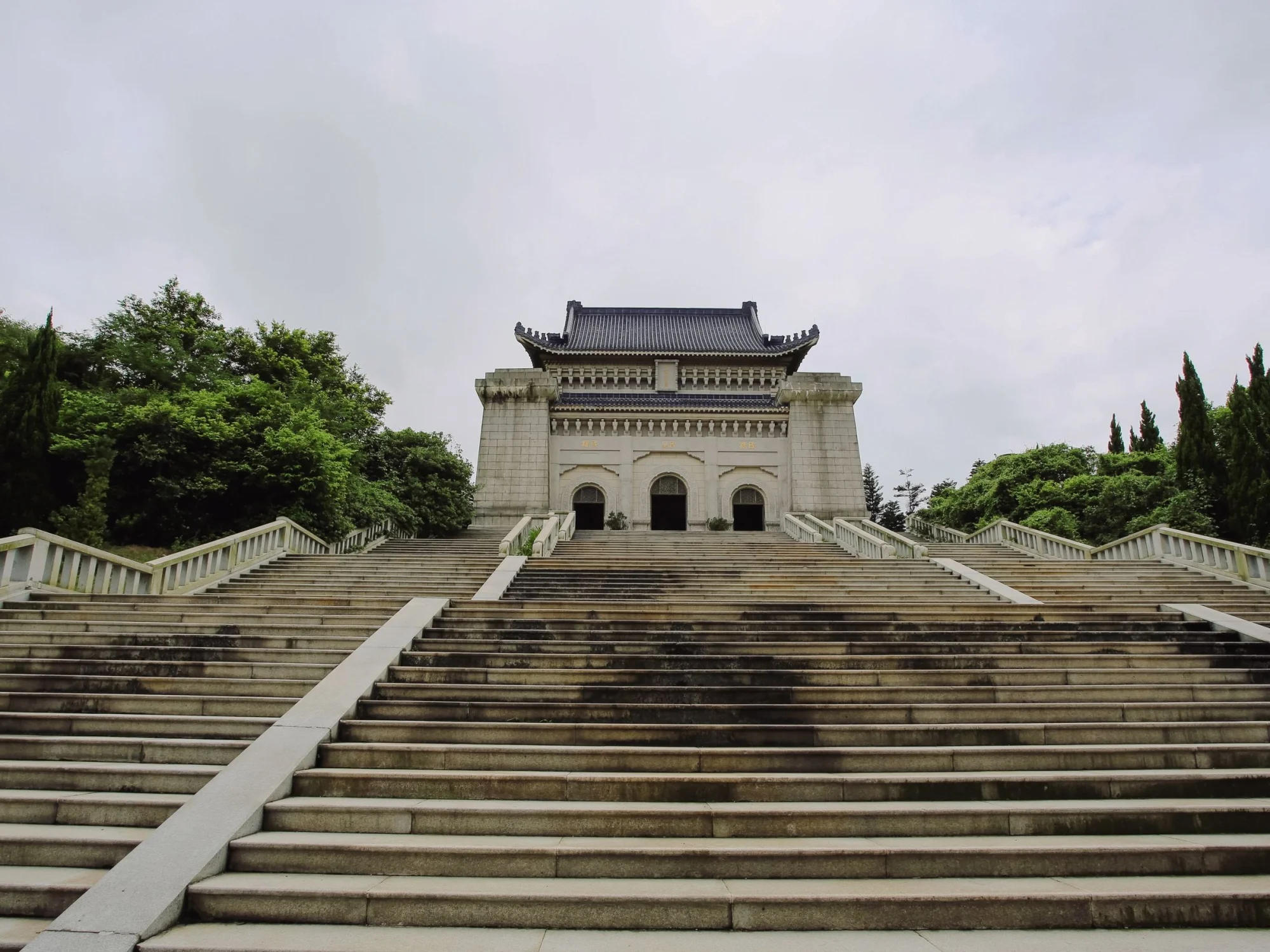 Majestic view of Dr. Sun Yat-sen's Mausoleum surrounded by greenery in Nanjing.
